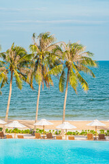 Naklejka premium Umbrella and deck chair around outdoor swimming pool in hotel resort