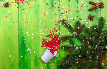 Christmas tree with spices on a green table Top view with copy space.