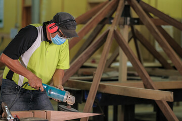 Carpenter making Tunjuk Langit or one of the roof structures. Hip Roof