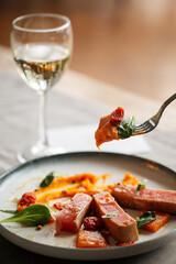 Closeup on eating gourmet roasted tuna with pumpkin puree