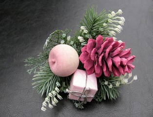 Christmas pink pine cone decorations on a black background.