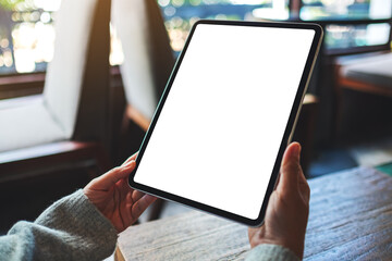 Mockup image of a woman holding digital tablet with blank white desktop screen