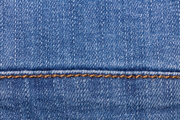 Close-up shot of blue jeans fabric with a seam. Copy space. Top view. Clothing store and shopping concept