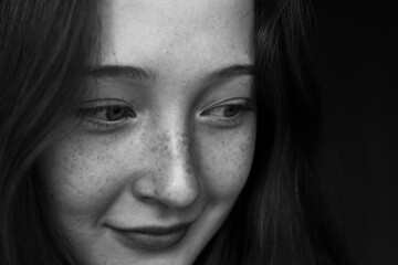 close up portrait of a young woman with freckles
