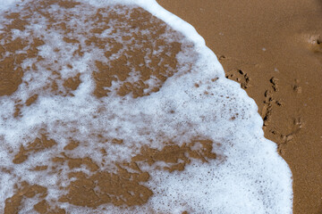 Smile draw on the shore of the sea