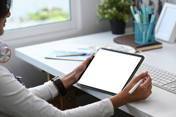 Close up view of an Artist or Designer working on digital tablet at the modern office.
