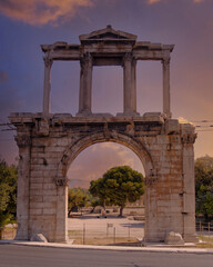 Fototapeta premium impressive Adrian's ancient arch ruins under fiery sky, Athens Greece