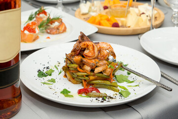 Thai spicy seafood salad and asparagus on a white plate. 