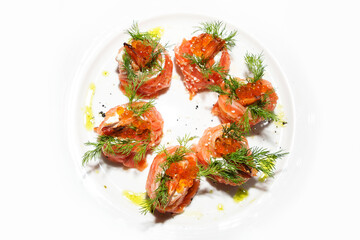 roll with caviar, salmon and fried shrimps, decorated with dill on a white plate. appetizer with seafood. Isolated, white background, close-up