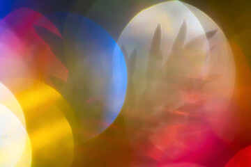 Beautiful defocused abstract blurred bokeh background. Silhouette of spruce branch with needles Christmas tree. Festive lens flare photo effect. Out of focus glowing holiday lights, shining texture.