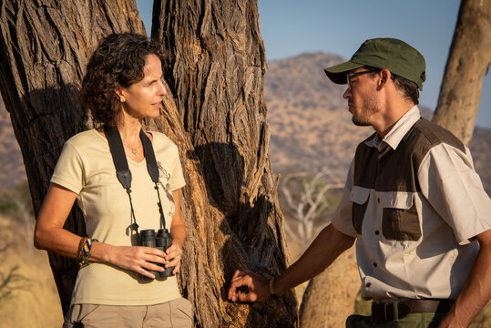 Close-up of brunette talking to safari guide