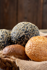 Wheat and rye bread. Rye and wheat bread of different shapes on a light gray table. Round wheat bread, buns and Burger buns on the table. The view from the top. Copyspace