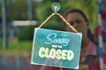Excuse me, we are closed in business with a woman's reflection. economic crisis concept