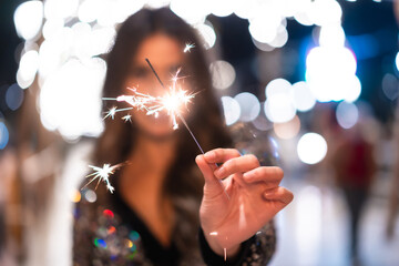 Winter lifestyle at Christmas. Brunette Caucasian girl in a fashionable dress with sequins, Smiling...