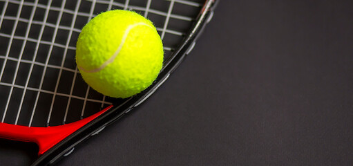 tennis racket with tennis balls in green color, isolated on black background, lighting detail sport concept