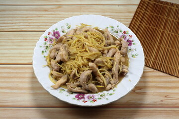Fried and stirred shredded fresh ginger with chopped chicken thigh on the plate. Famous traditional menu in Asia restaurant. 