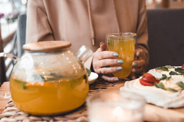 Tea with sea-buckthorn berries and ginger, selective focus