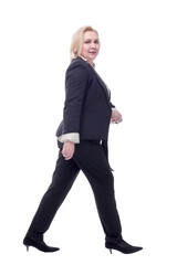 Happy business woman walking towards camera and smiling