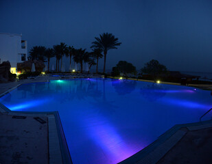 Pool illuminated at night in the hotel