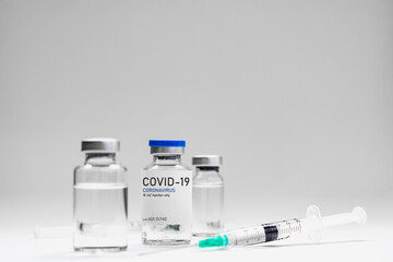 Covid19 Vaccine syringes and medicine bottles in white environment