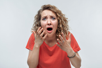 Image of scared blonde girl covering her mouth with hands. Fright, phobia and facial expression...