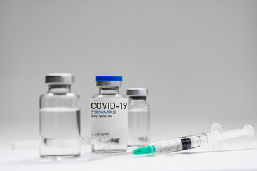 Covid19 Vaccine syringes and medicine bottles in white environment