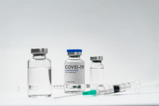 Covid19 Vaccine syringes and medicine bottles in white environment