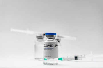 Covid19 Vaccine syringes and medicine bottles in white environment
