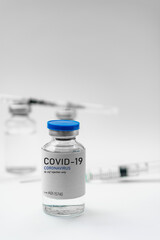 Covid19 Vaccine syringes and medicine bottles in white environment