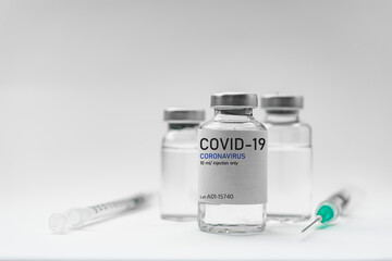 Covid19 Vaccine syringes and medicine bottles in white environment