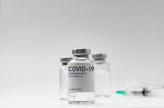 Covid19 Vaccine syringes and medicine bottles in white environment