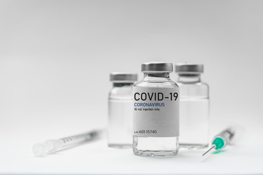 Covid19 Vaccine syringes and medicine bottles in white environment