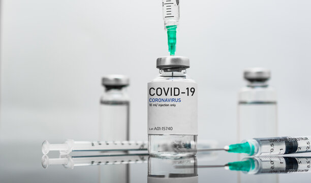 Covid19 Vaccine syringes and medicine bottles in white environment