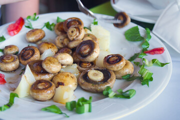 Delicious vegetarian dish - buttered grilled mushrooms with herbs