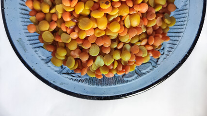 split chickpeas in glass bowl on a white isolated surface