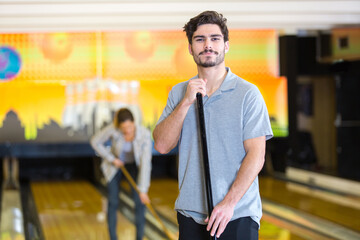 man cleaning bowling alley