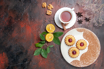 top view little cookies with cup of tea on dark background sugar biscuits cake sweet