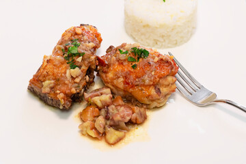 stewed chicken with white rice and chestnuts sauce on a dish