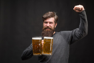 Beer. Oktoberfest. Handsome man drinking beer of glass. Smiling bearded hipster drinking craft...