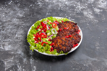 front view tasty meat cutlets with fresh salad on a grey background photo dish meat food
