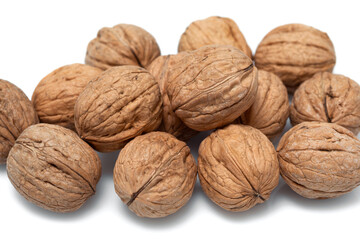 Walnuts in their shells close up on a white background