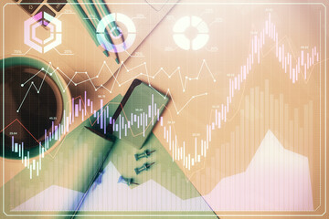 Double exposure of forex graph drawing over desktop background with computer. Concept of financial analysis. Top view.