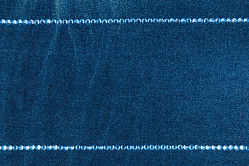 Two line of blue rhinestones on denim. Top view.