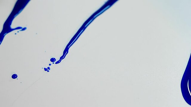 Close-up of pouring paint onto a surface. Creation of a picture by the method of free improvisation of liquid pouring. Camera movement.