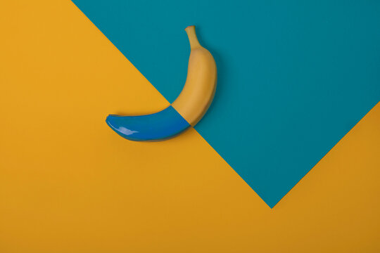 half painted blue yelllow banana on background, geometry