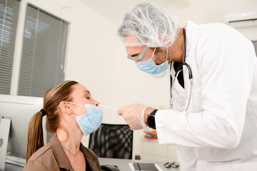 attractive young woman having a PCR nasal test with swab for coronavirus virus detection testing in doctor office