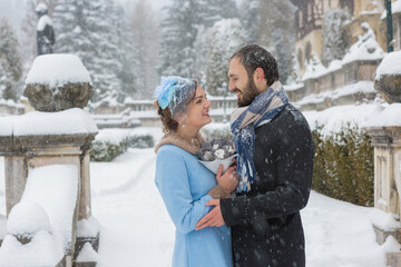 Happy Young Couple in Winter Park. Family outdoors at the castle.