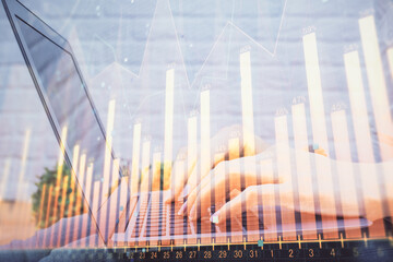 Multi exposure of woman hands typing on computer and forex chart hologram drawing. Stock market analysis concept.