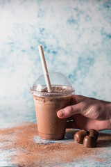 Holding chocolate smoothie take a way