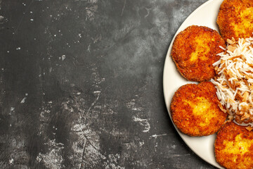 top view delicious fried cutlets with cooked rice on dark background meat dish meal
